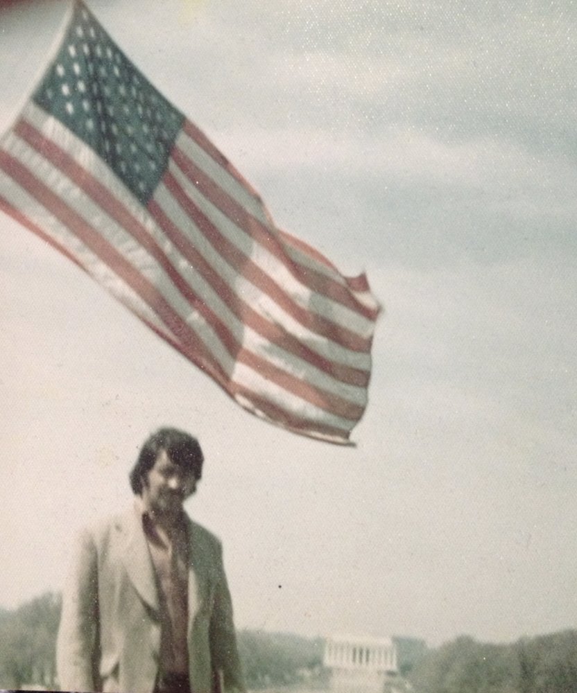 Our late father, Baba, standing under an American flag in Washington, D.C.