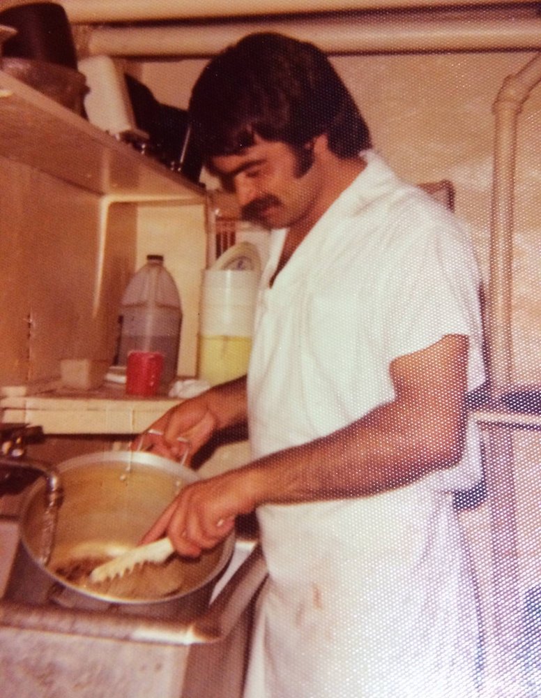 Our late father, Baba, cooking in a restaurant kitchen