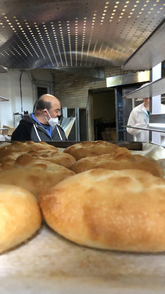 Our late father, Baba, in the bakery with fresh Thumb Bread®