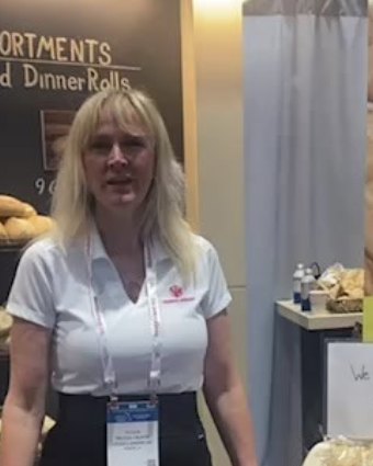 Melissa Calrow, sales representative for Vieira's Bakery, at a Vieira's Bakery trade show booth