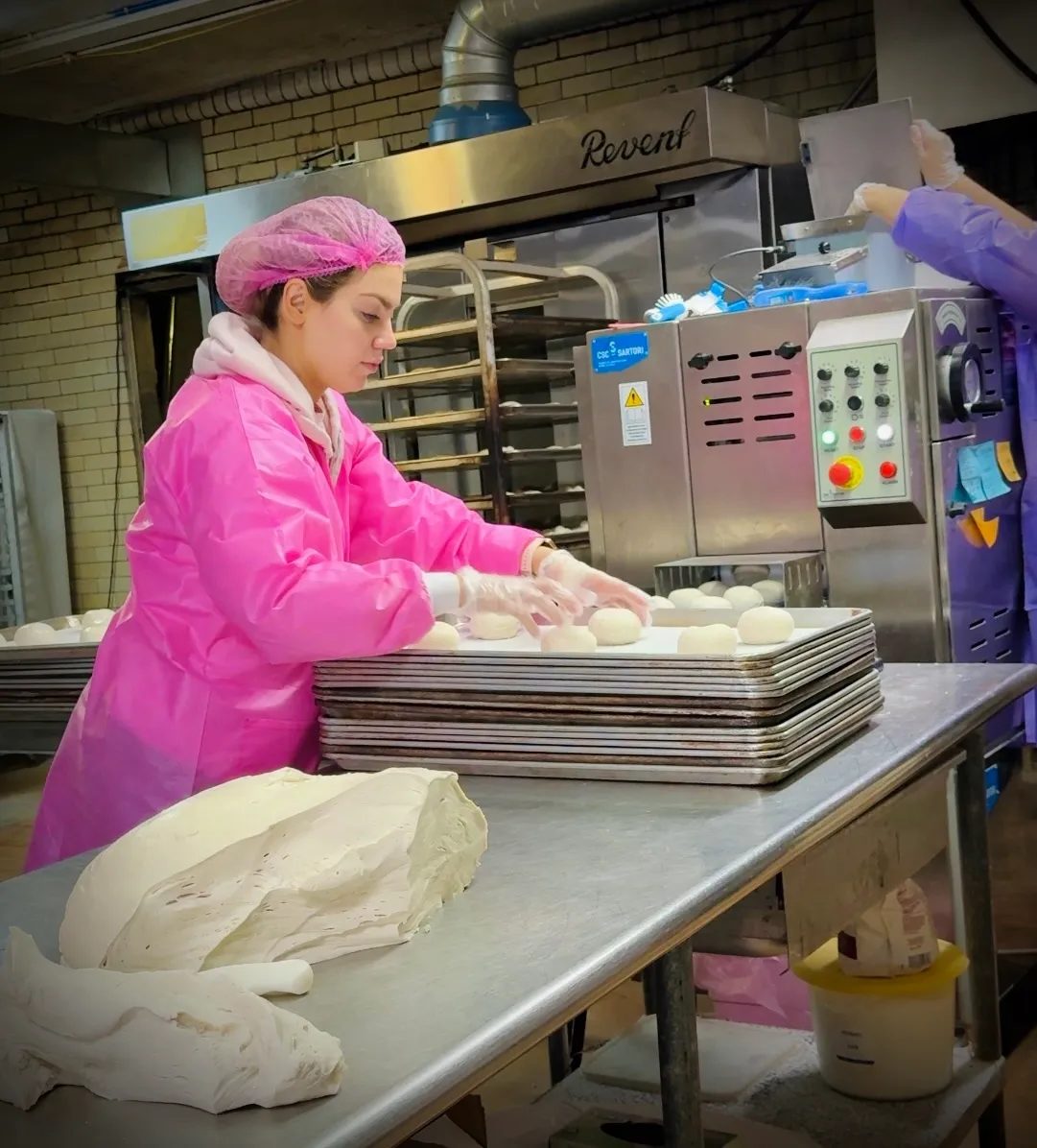 Arzu Esendemir shaping Thumb Bread® dough by hand in the bakery