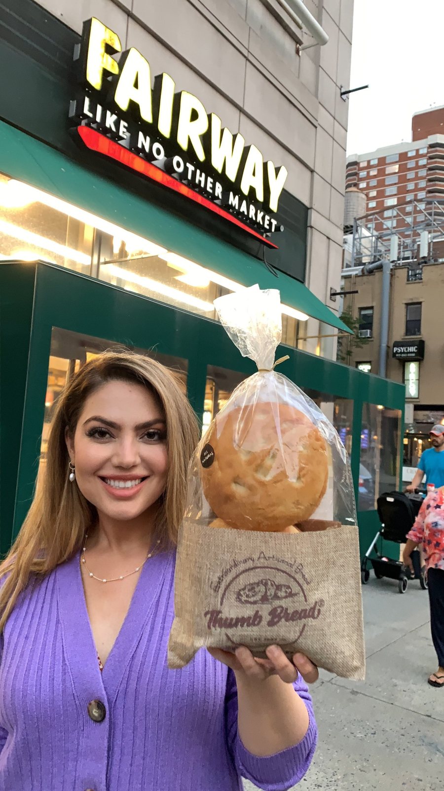 Arzu Esendemir holding Thumb Bread® in its burlap bag outside Fairway Market in New York City