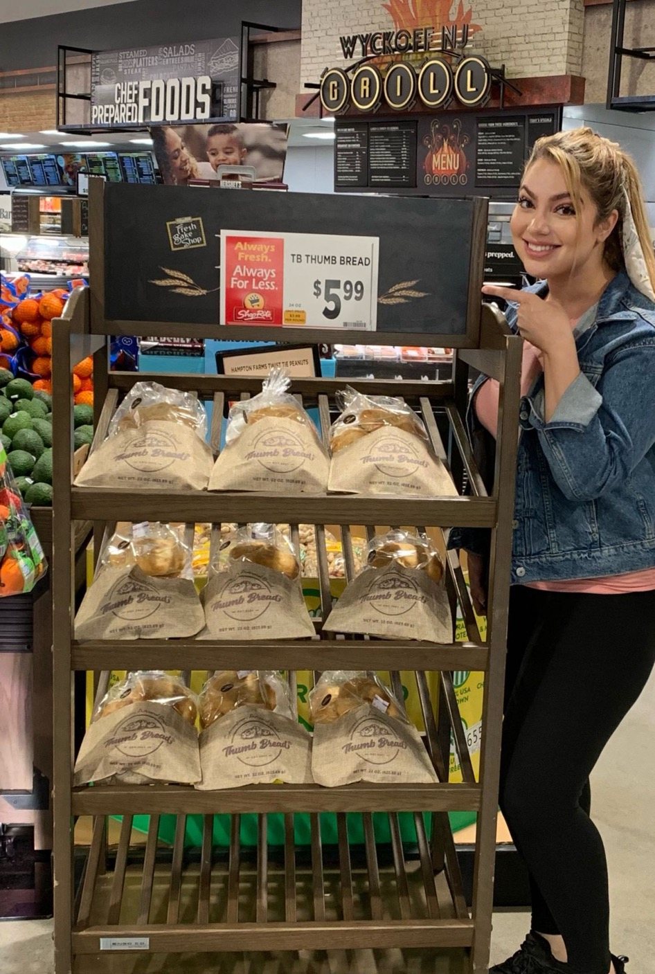 Arzu Esendemir pointing to a Thumb Bread® display at ShopRite of Wyckoff, NJ, priced at $5.99