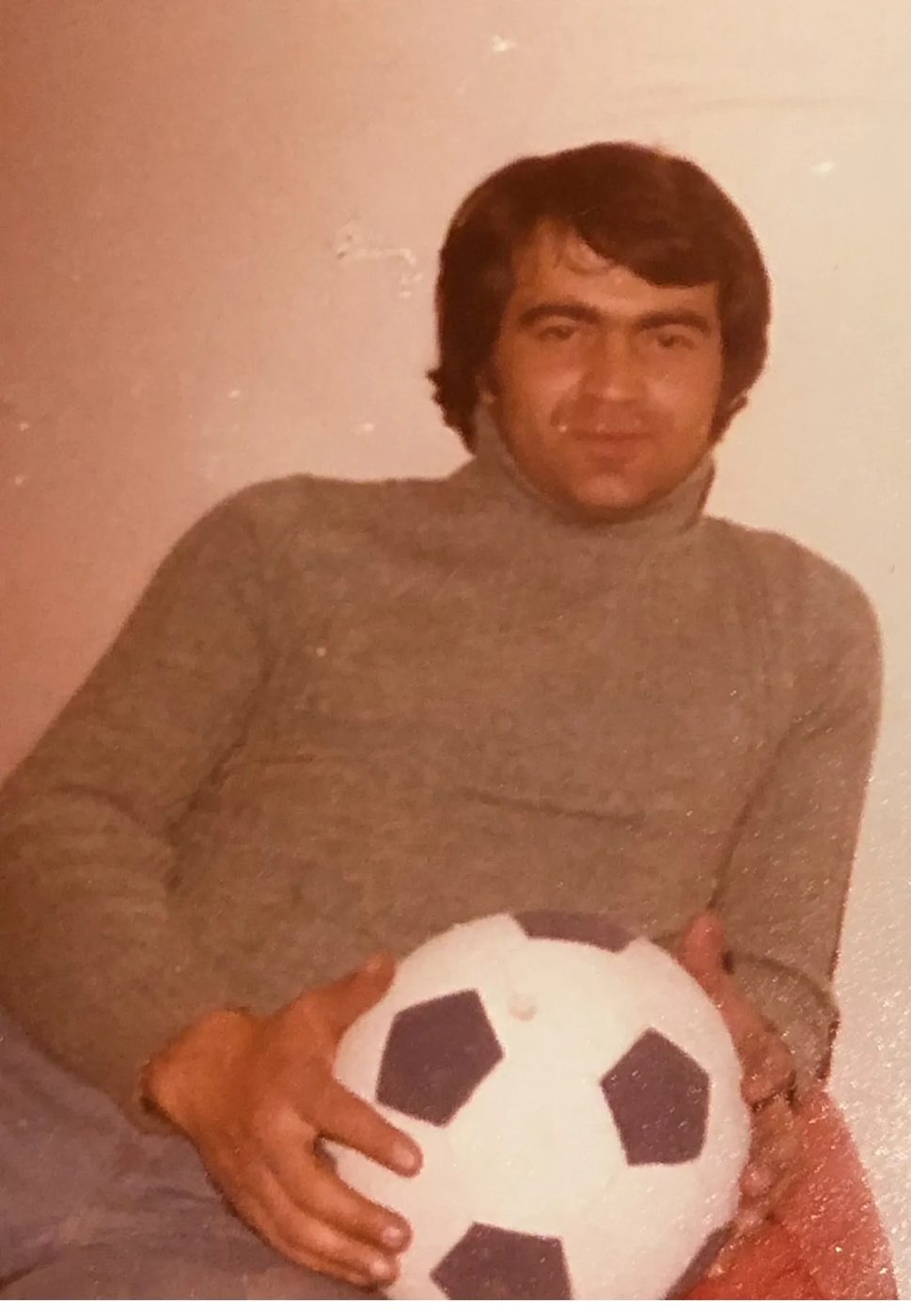 Baba holding a soccer ball