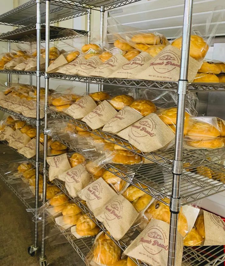 Racks of freshly packed Thumb Bread® in burlap bags