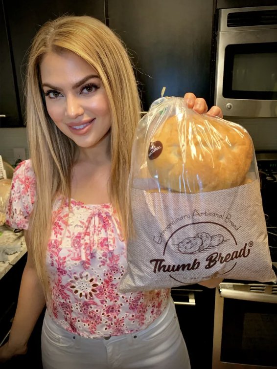 Arzu Esendemir holding up Thumb Bread® in its bag