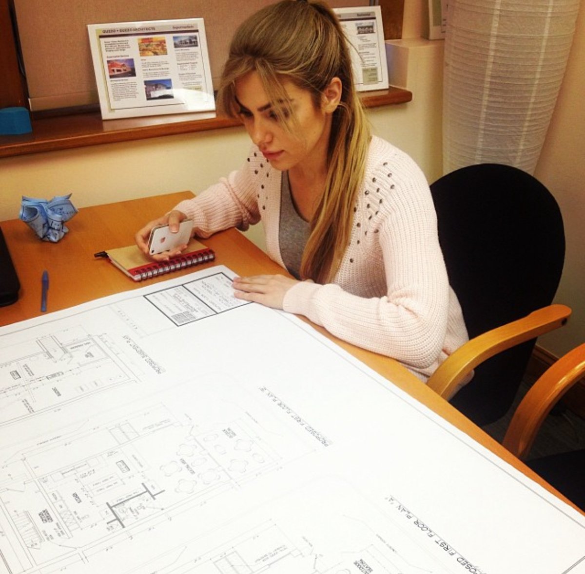 One of the Esendemir sisters going over the Flatbread Grill® restaurant blueprints